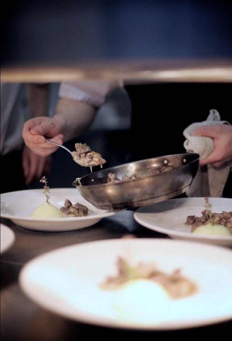Chef carefully arranging a mezze platter